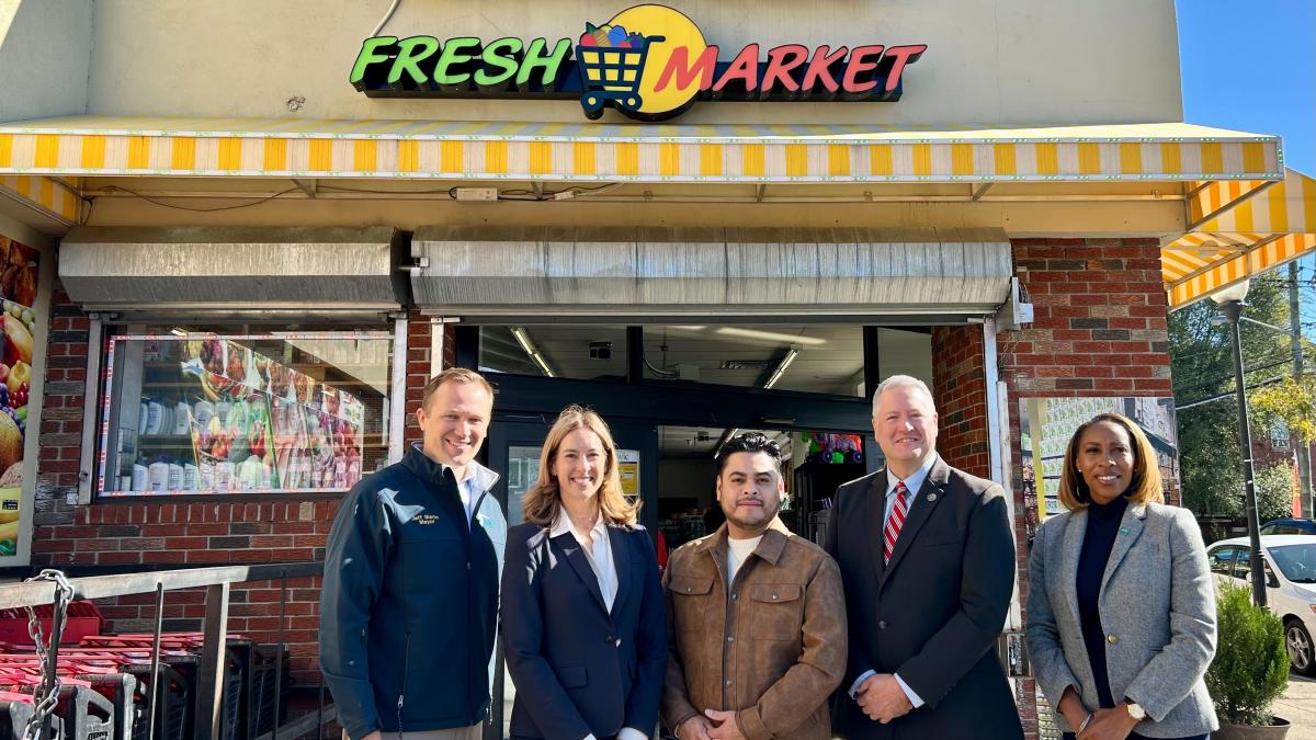 Rep. Sherrill outside of Compare Fresh Market