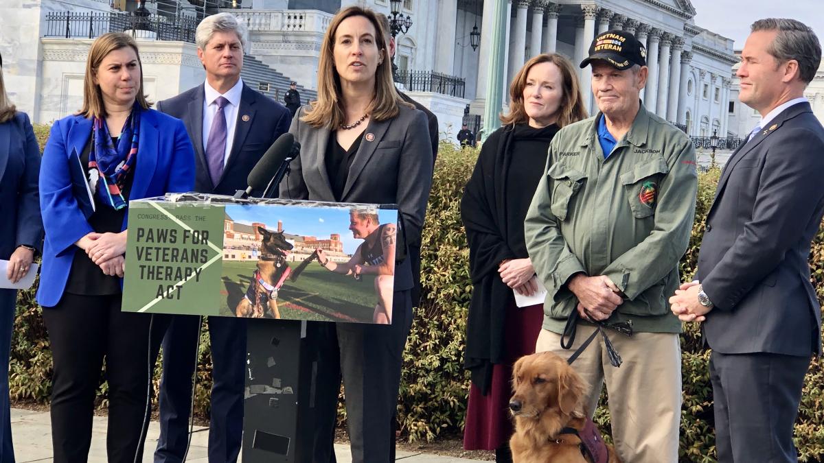 Rep. Sherrill speaks at a press conference with Vietnam Veteran Walter Parker and his service dog, Jackson, at the Capitol last year