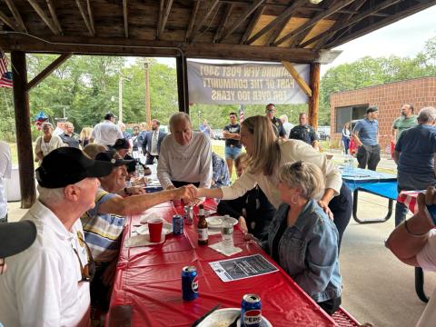 Rep Sherrill shakes the hand of a fellow veteran