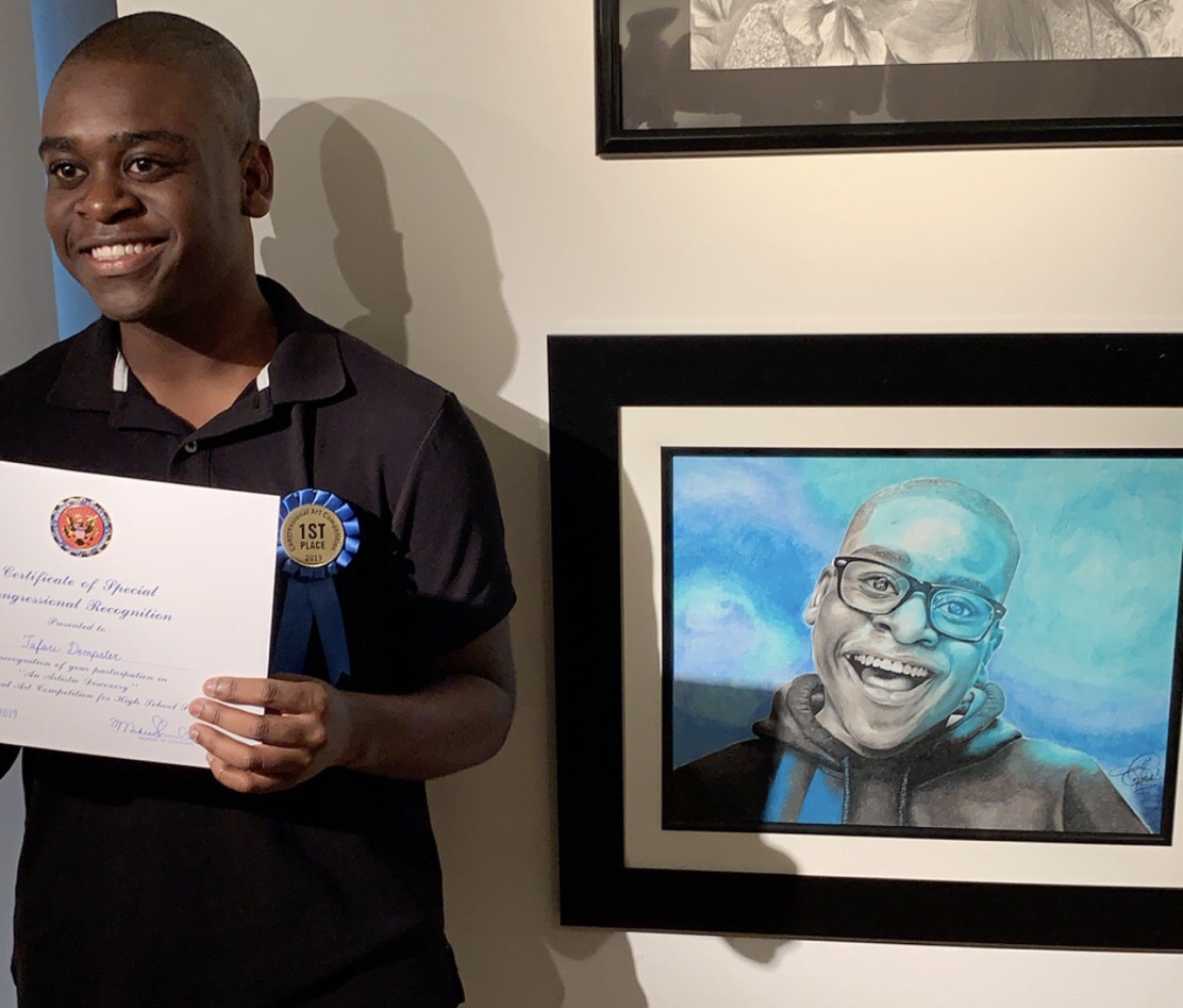Tafari Dempster stands next to his winning piece